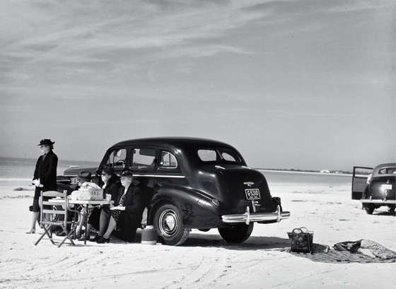 Picnic, Sarasota, Fla. Marion Post Wolcott, 1941. Image c/o LACMA. Black-and-white photograph features three women picnicking out of a car in Sarasota, FL, in 1941.