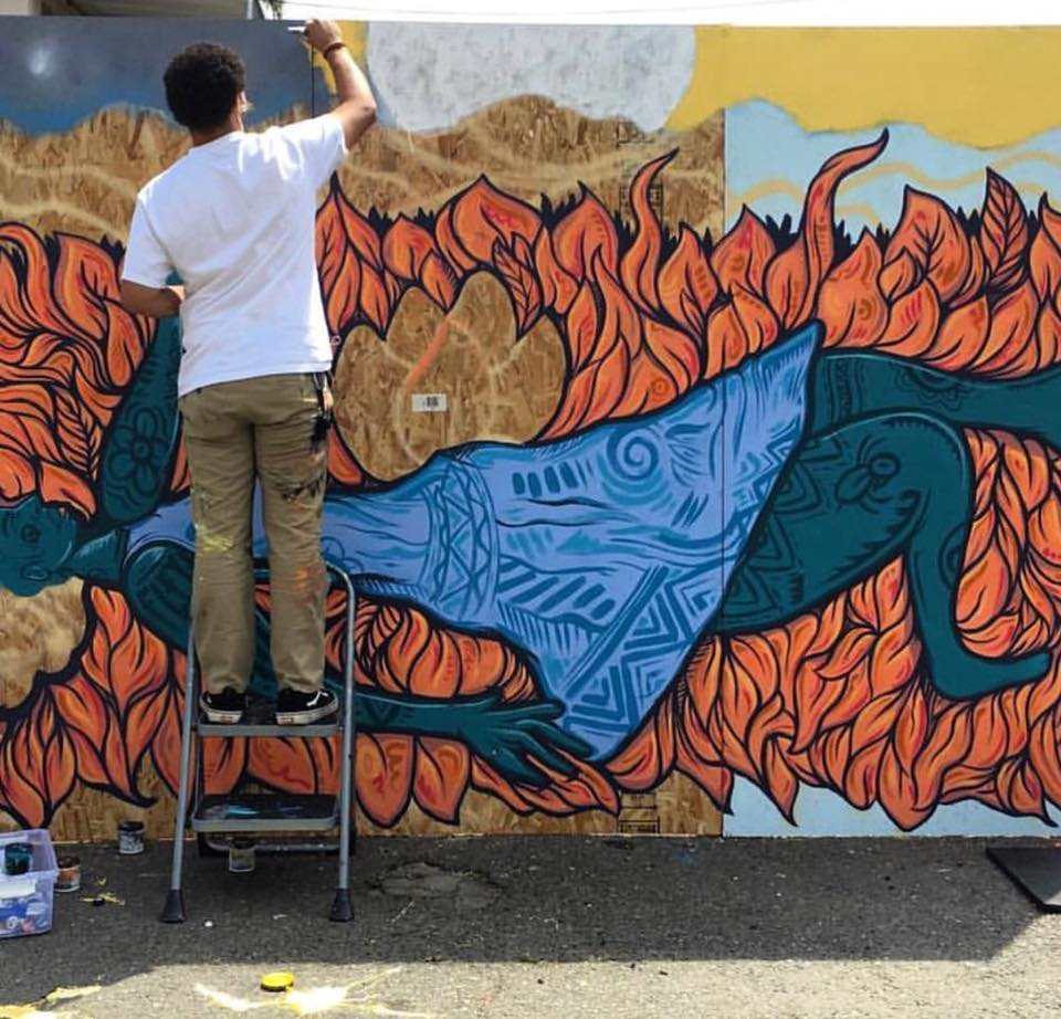 Aik Brown creates a mural, c/o Wide Open Walls Facebook